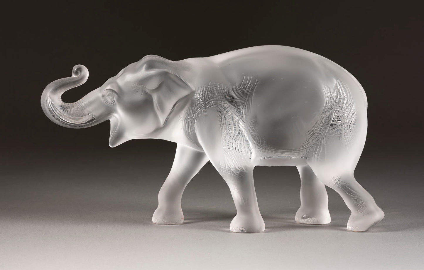 A large, naturalistic, signed sculpture of a striding Sumatran Elephant by Lalique