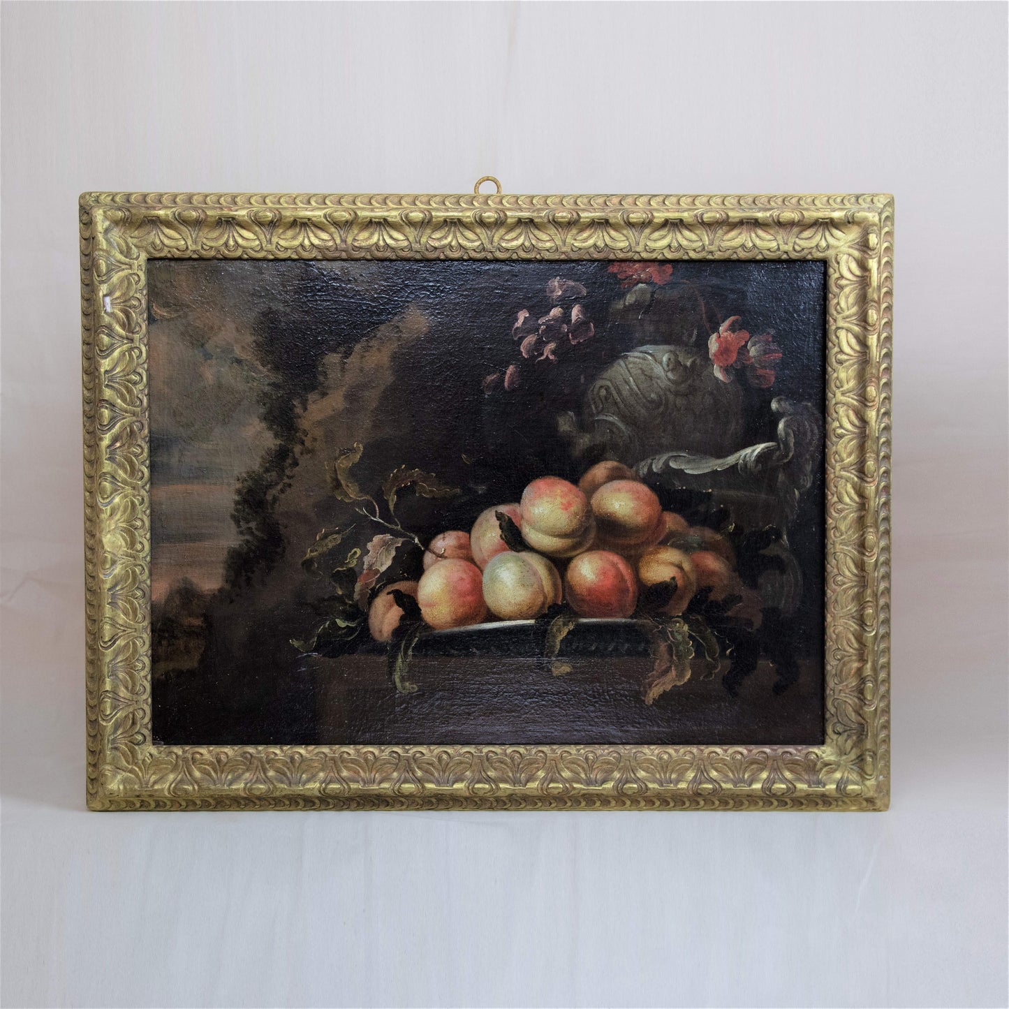 A magnificent Italian Baroque still life with peaches on a charger and views in the distance, from a noble collection c.1700