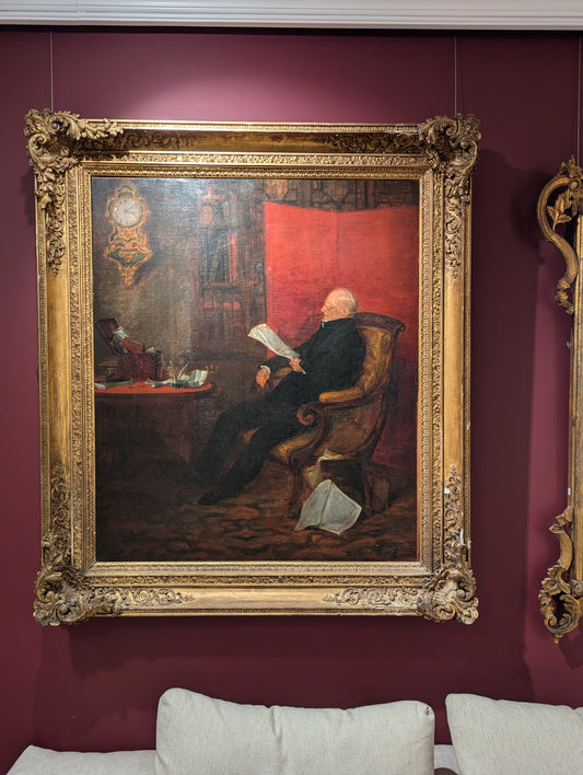 A Large 19th Century portrait of an Elderly Gentleman seated and reading in his Study, English School